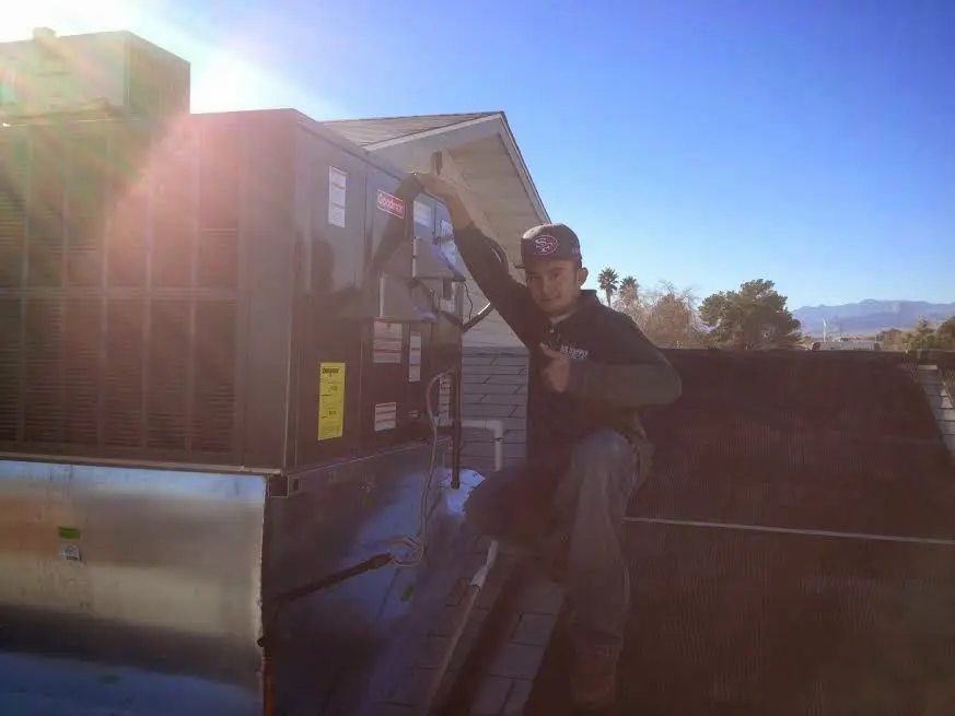 HVAC technician performing Boiler Repair on a rooftop unit in Fort Washington